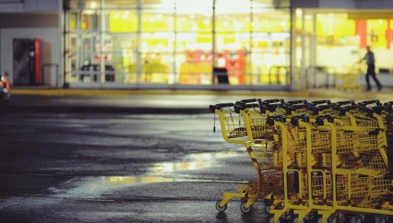 Yellow shopping carts on concrete ground